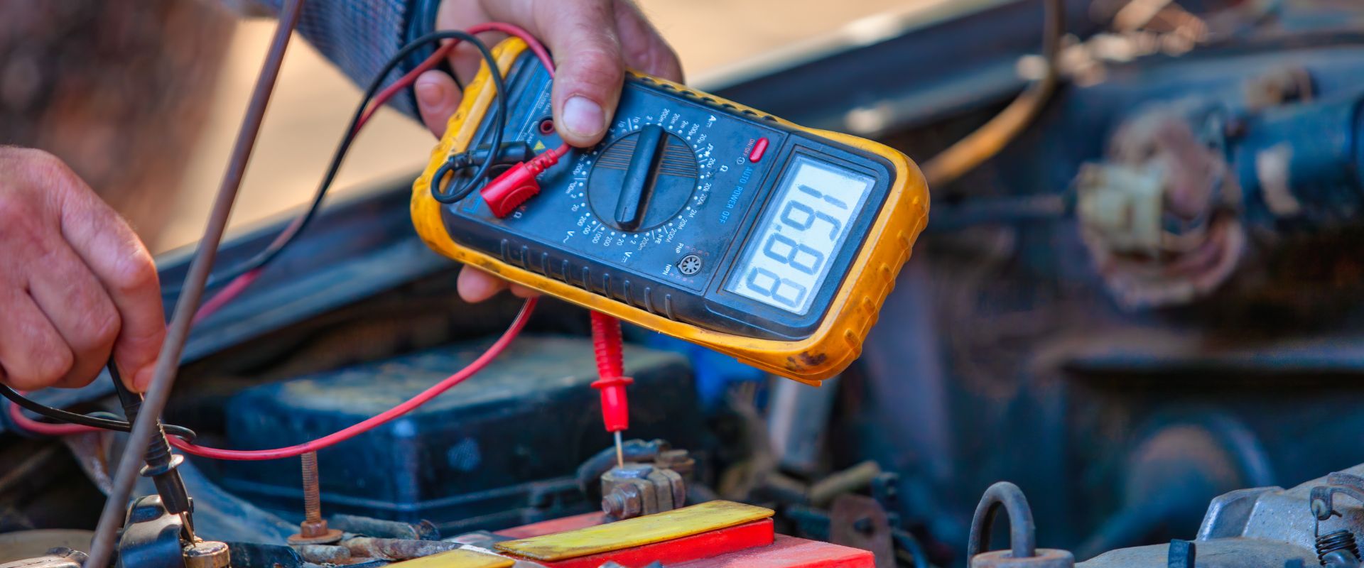Person Testing Car Battery