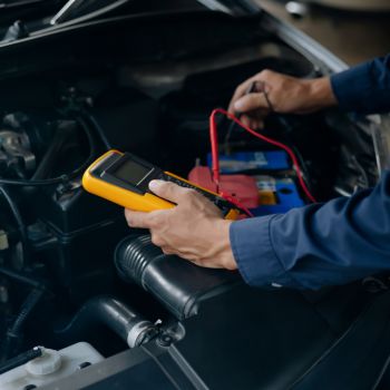 Person Testing Car Battery