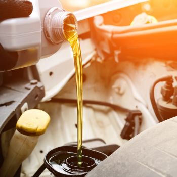 Person Pouring Oil into Vehicle